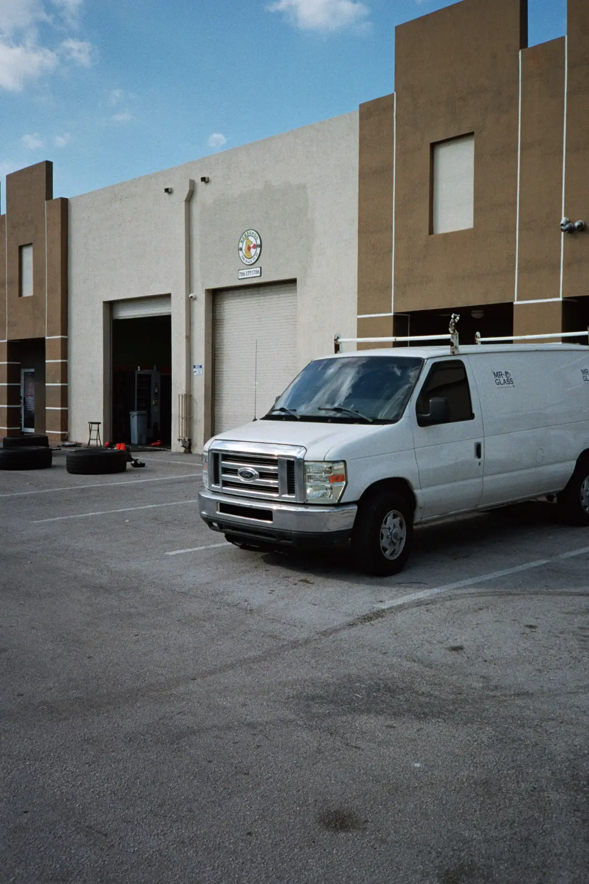 White work van parked outside a small business