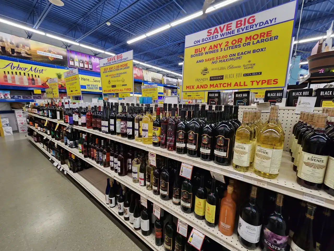 liquor store aisle with variety of wine bottles displayed on shelves