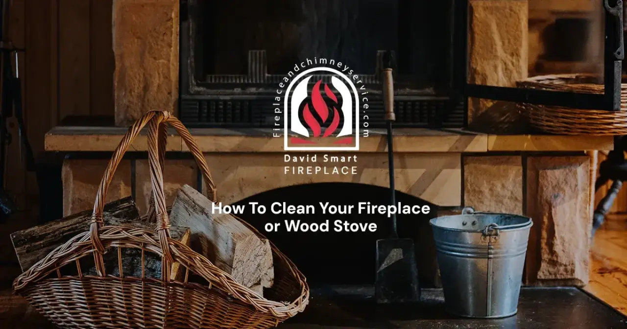 A fireplace with a wicker basket of firewood, ash bucket, and cleaning tools in front.