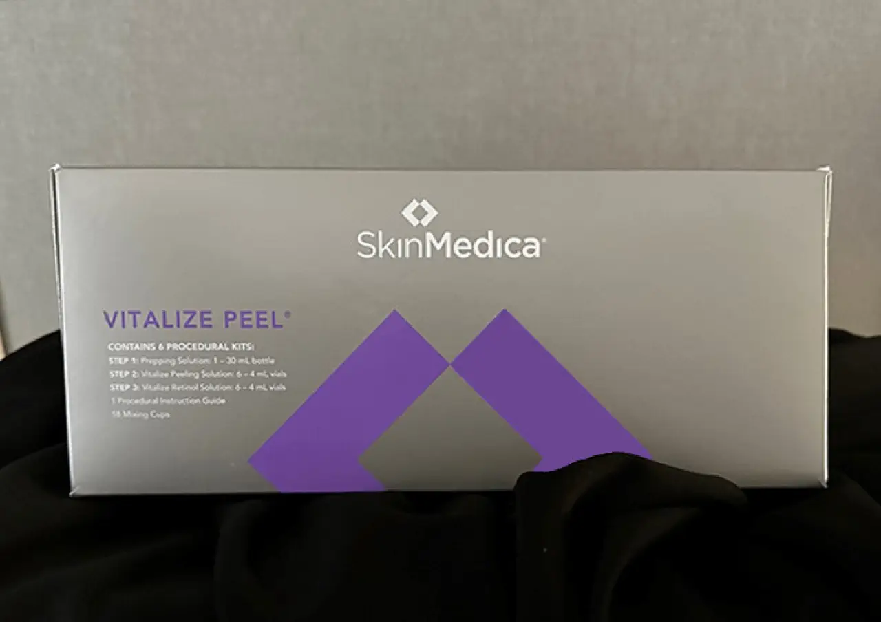 A SkinMedica Vitalize Peel box is displayed against a neutral background and black cloth.