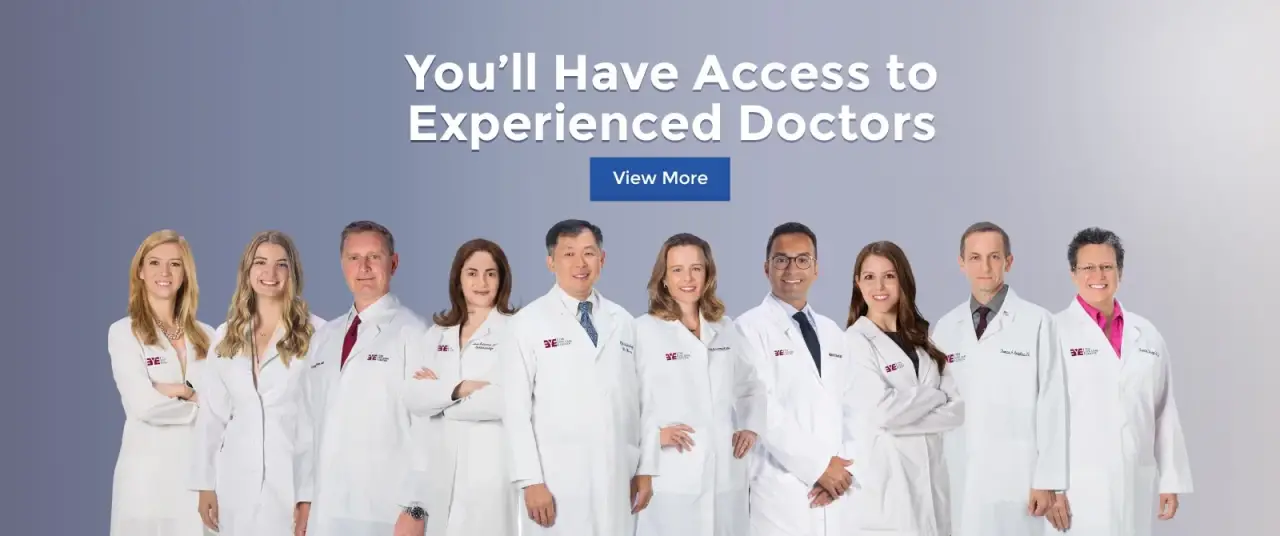 eleven doctors of the eye care center in white coats stand smiling
