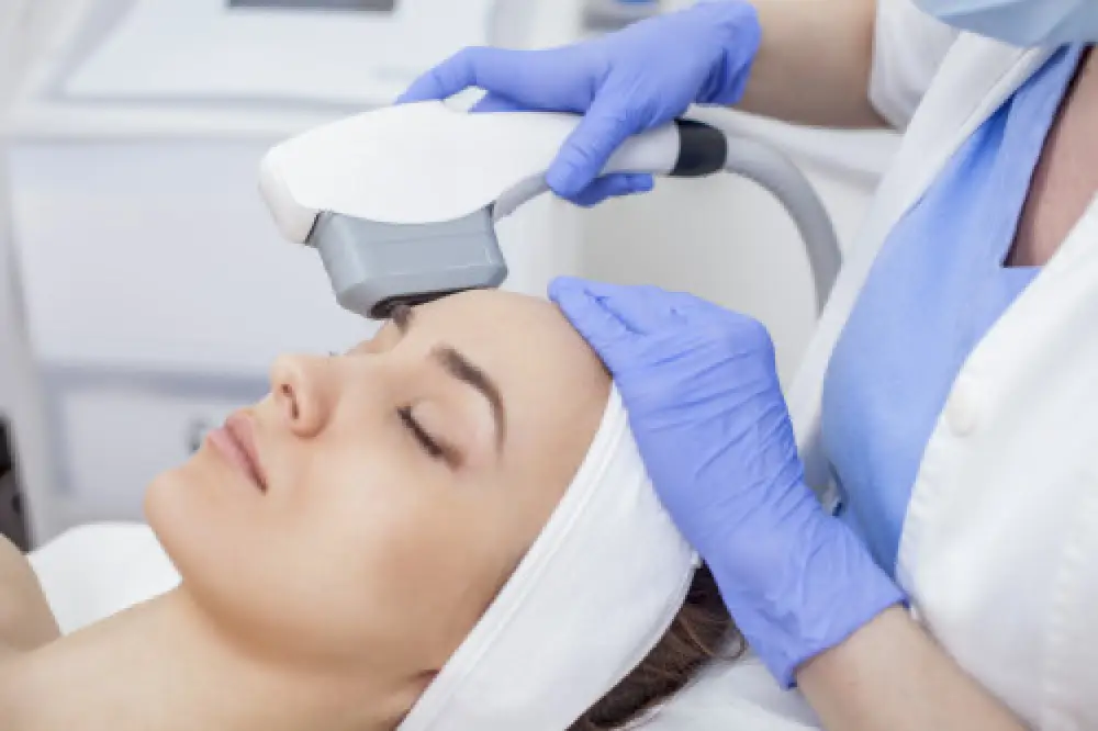 A woman receiving an eye treatment.