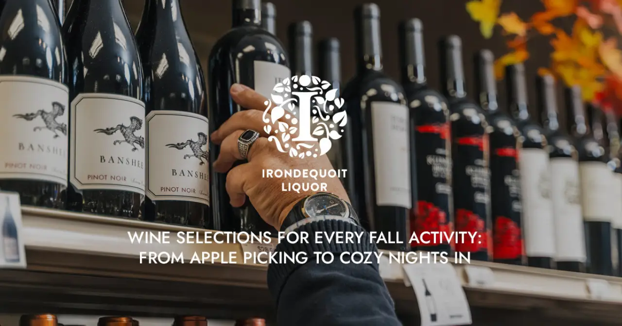 hand reaching for a bottle of red wine on a liquor store shelf, surrounded by other wine bottles