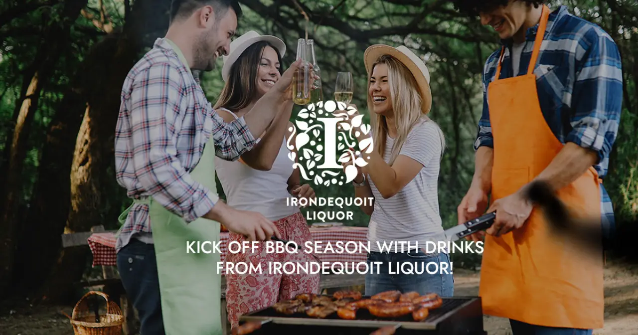 four friends enjoy a BBQ in a park, toasting drinks near a grill with food under string lights