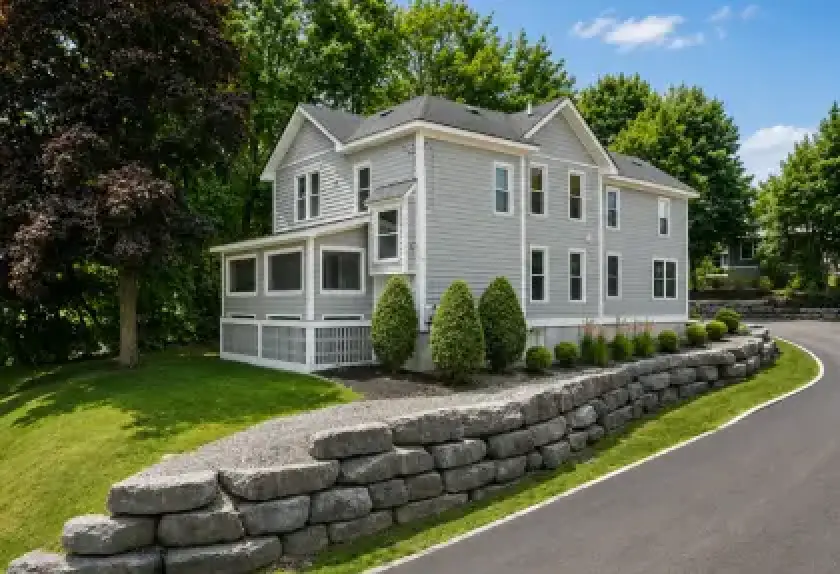 Two-story student rental house with landscaped grounds in Cortland, New York.