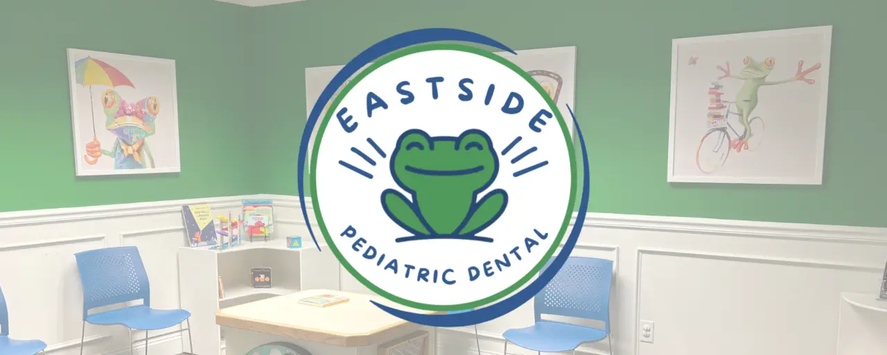 Pediatric dental office with green walls, blue chairs, and playful frog artwork on the walls.