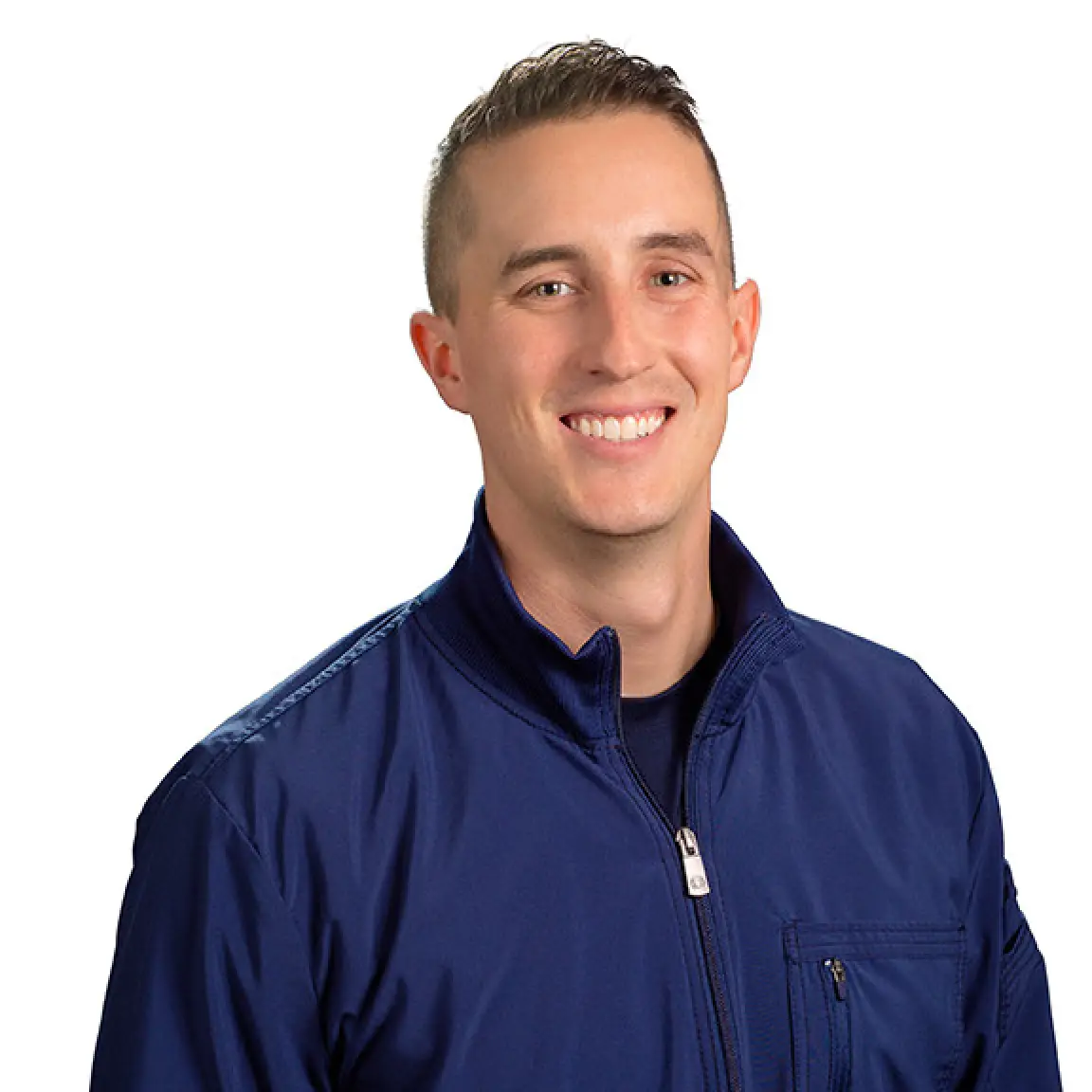 Doctor Andrew Winslow in a blue zip-up jacket poses against a plain white background.
