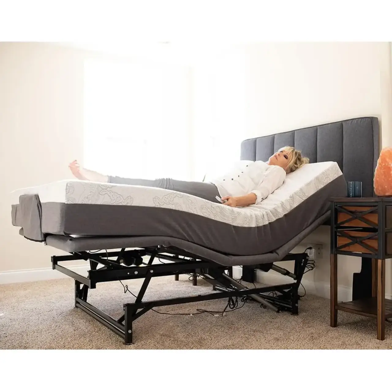 Woman reclining on a raised Flex-A-Bed adjustable bed.