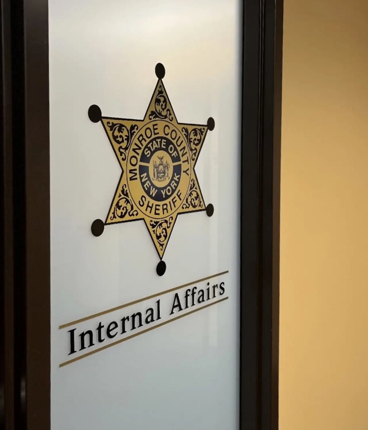 Monroe County Sheriff badge and Internal Affairs sign on an office door.