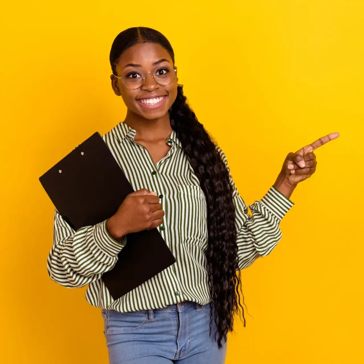 Smiling woman holds clipboard and points right, standing against a bright yellow background.