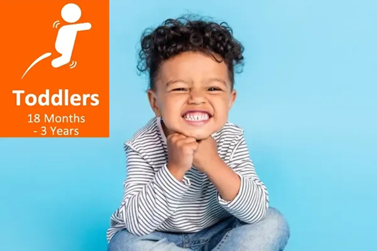 Smiling toddler in striped shirt sits against blue background; Toddlers 18 Months - 3 Years text.