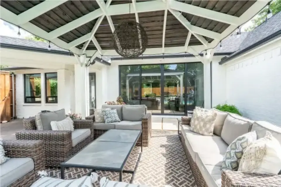 Covered outdoor patio with wicker furniture and seating area