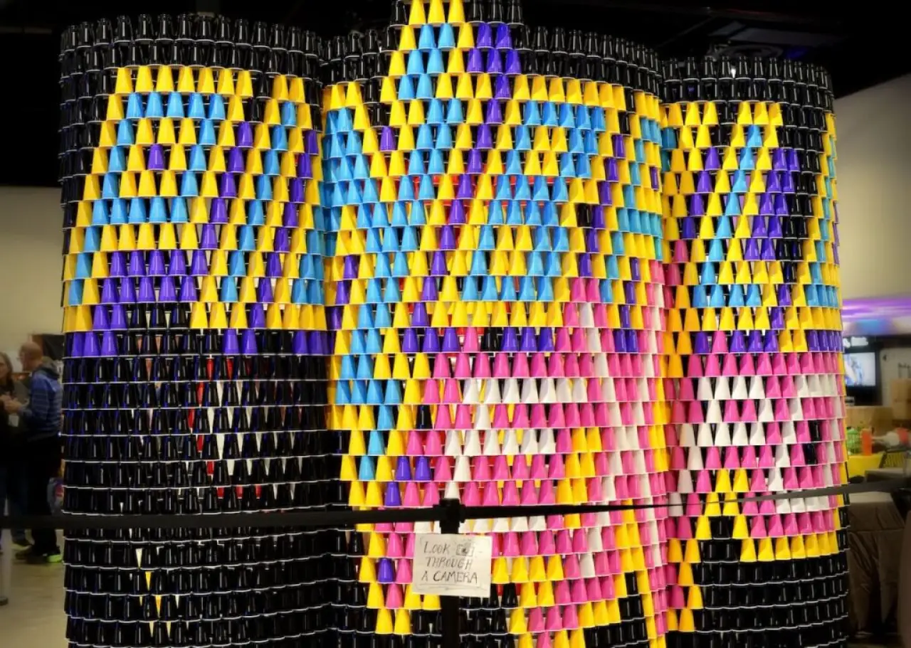 Colorful pinball-themed cup art display at Pinball Expo