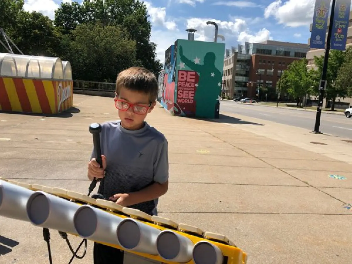 A boy plays the marimba at Martin Luther King Jr. park