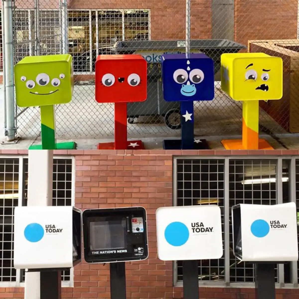Recycled newspaper boxes as little libraries painted green red and featuring cartoon faces