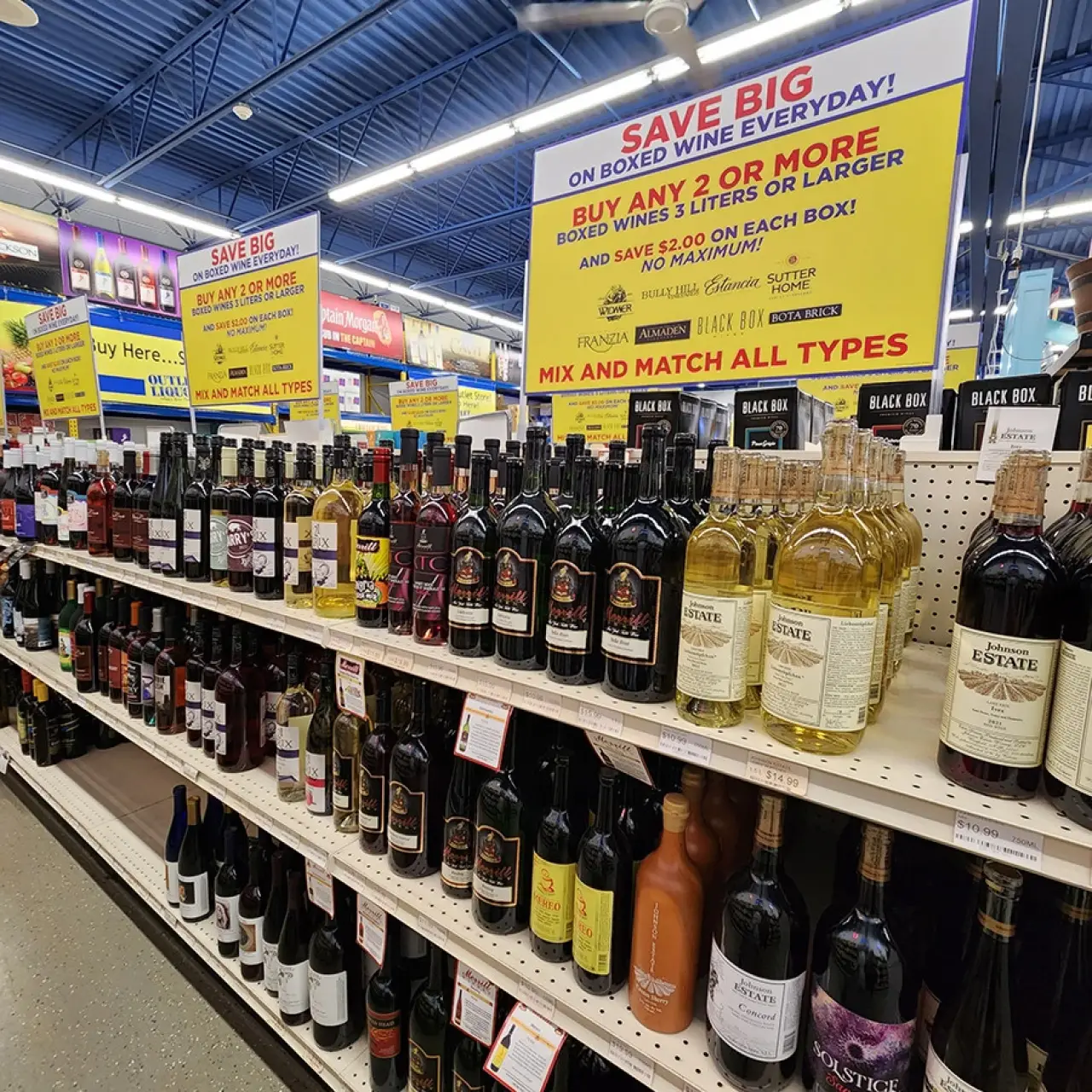 grocery store wine aisle with various boxed and bottled wines on display