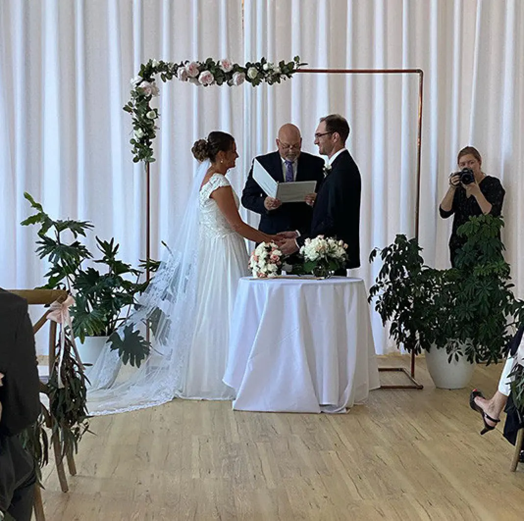 Bride and groom with officiant