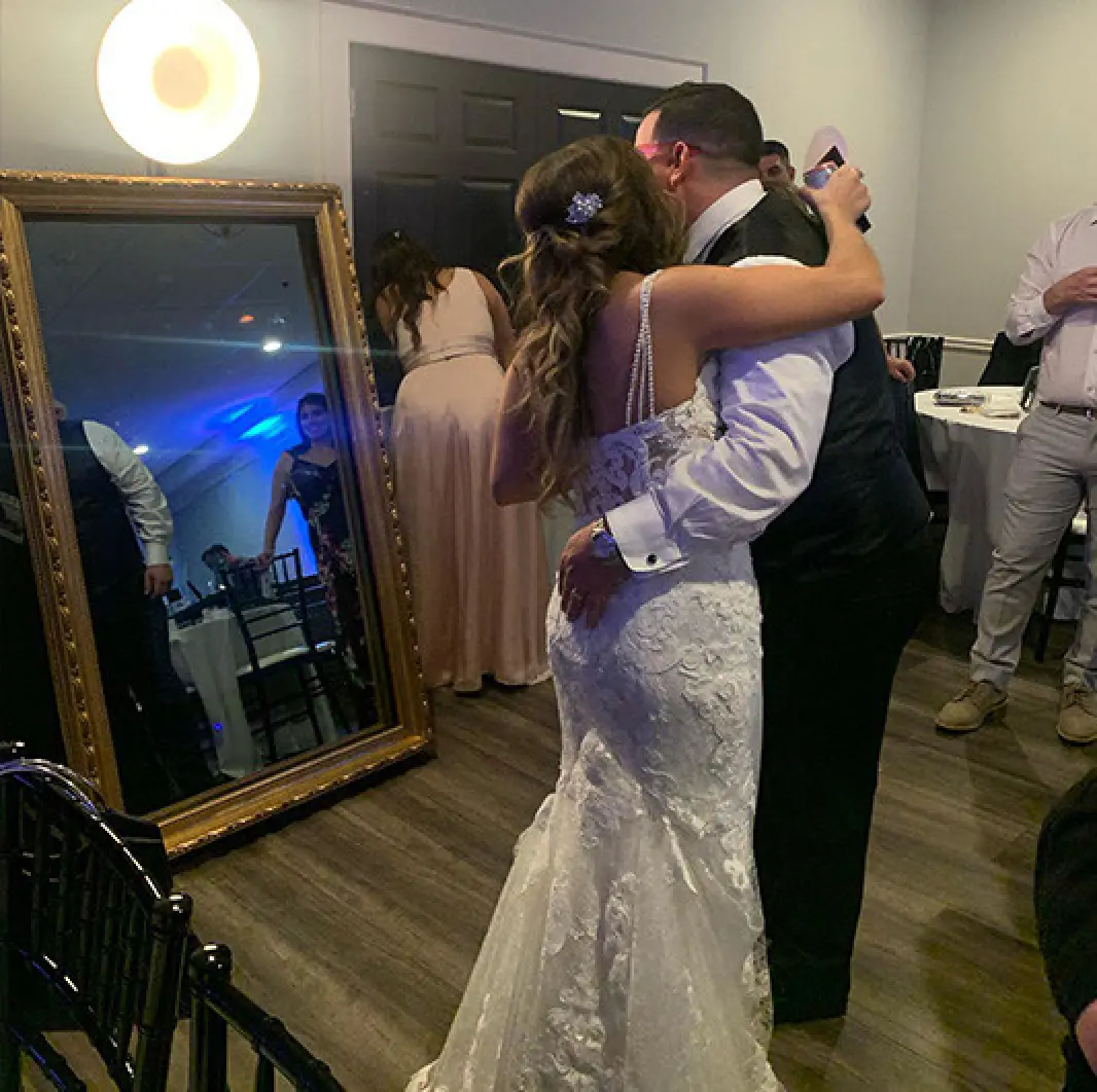 Bride and groom posing with photo mirror