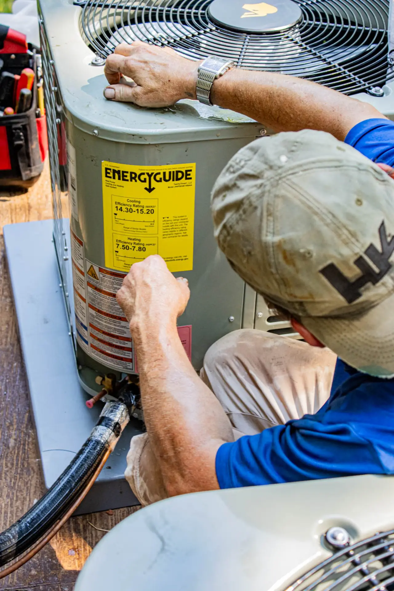 Hulsey employee checking AC unit labels and connections