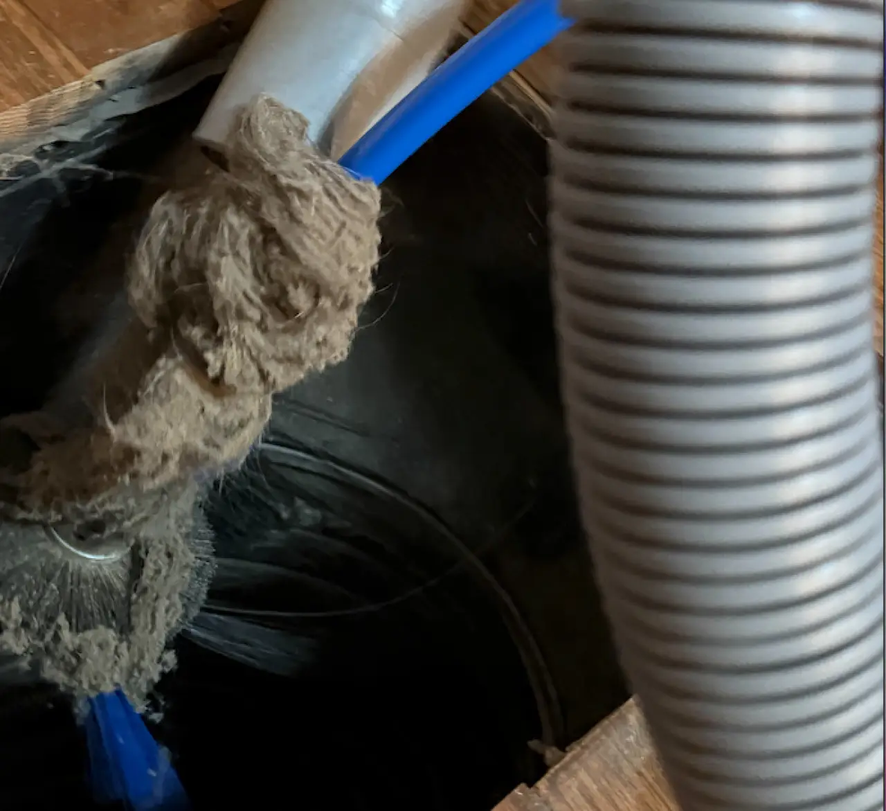 Air duct being cleaned with a brush