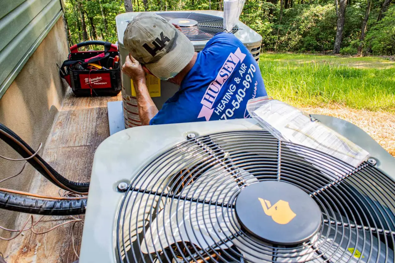 Hulsey employee working on an AC unit outside