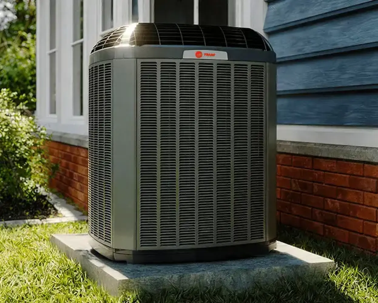 Trane outdoor unit installed on a concrete pad beside a home