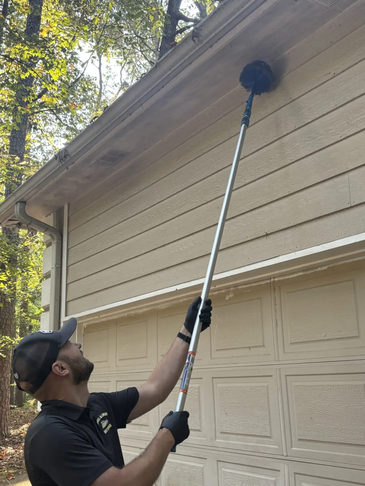 Daniel & Lawson Pest Control technician treating a home exterior
