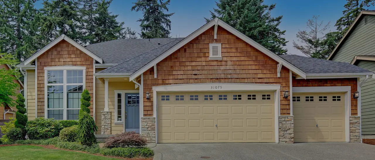 Suburban home with three-car garage and landscaped front yard