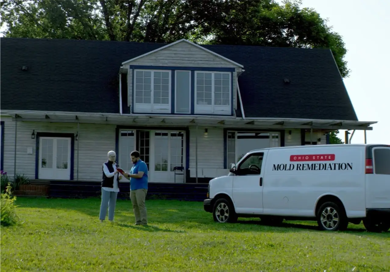A white truck with the Ohio State Mold Remediation logo parked in front of a house.