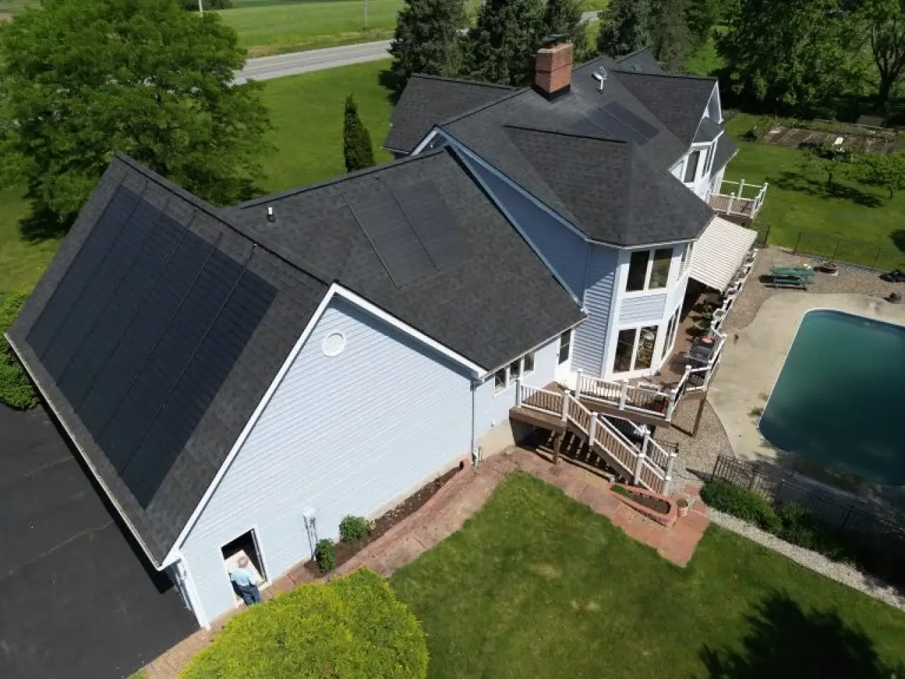 beautiful large 2 story home with solar roofing system and black solar shingles