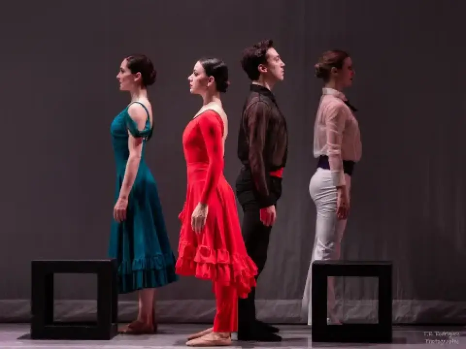 Four dancers stand back to back onstage in Carmen.