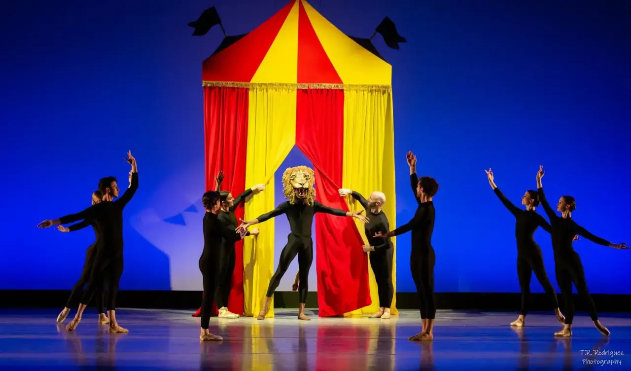 Ballet dancers perform around a circus tent with a lion character.