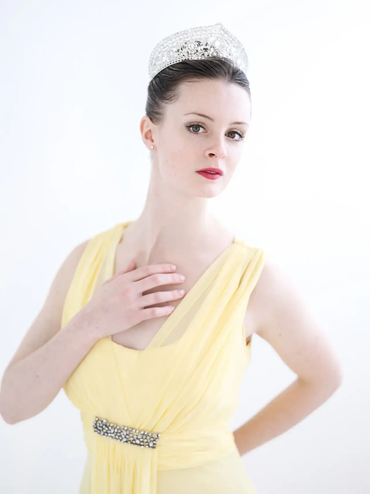 Ballet dancer in a yellow costume and jeweled crown.