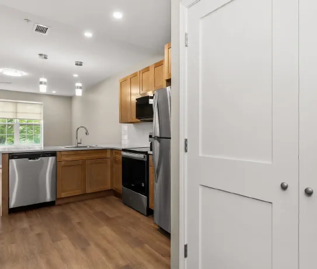 Modern apartment kitchen with stainless steel appliances at Empire Blvd. Estates