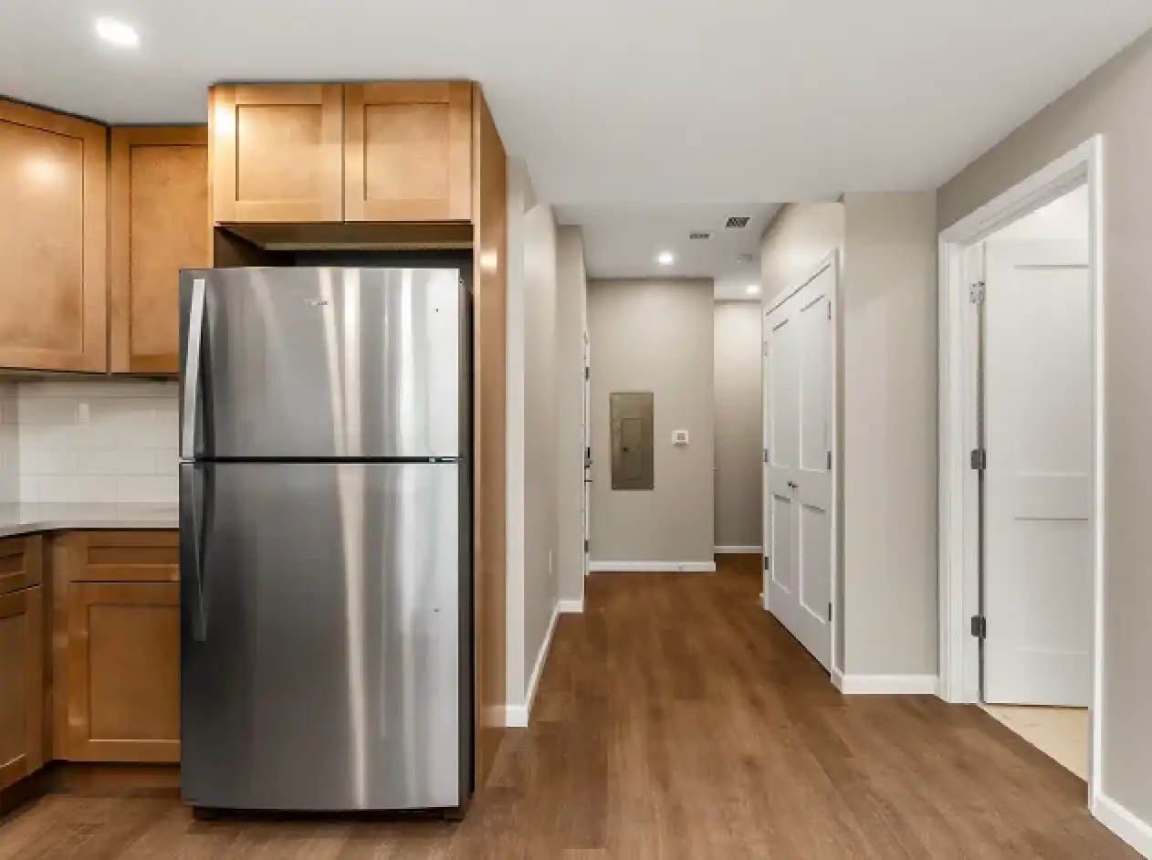 Open apartment kitchen and entryway at Empire Blvd. Estates