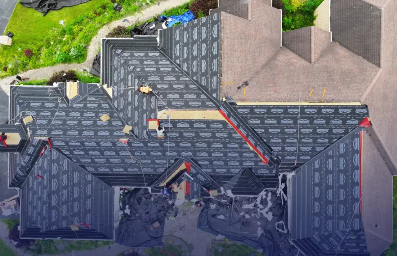 Construction being done on a residential roof.