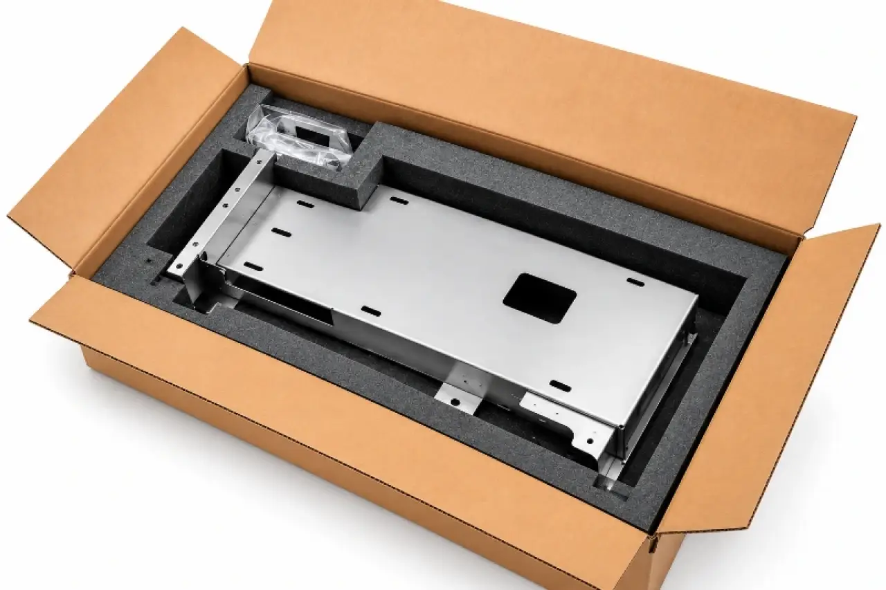 Fabricated sheet metal assembly packed in custom foam dunnage inside a shipping carton