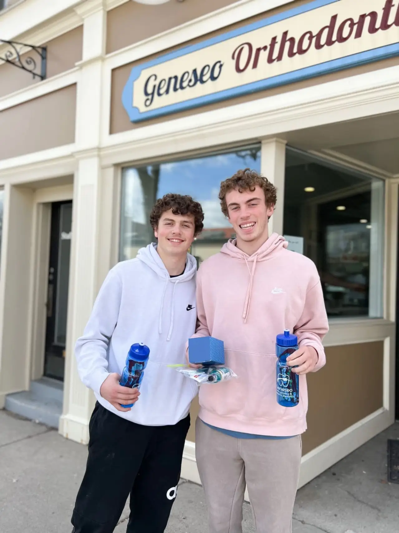 Two boys smiling after braces removal