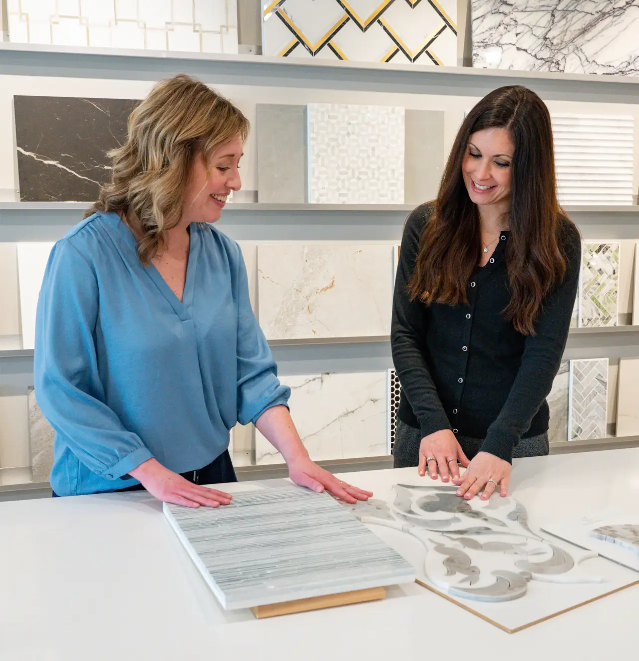 women at desk pointing at interior design plans