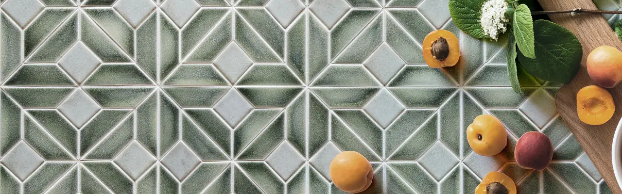 Geometric green and white tile pattern with apricots and green leaves on the side.