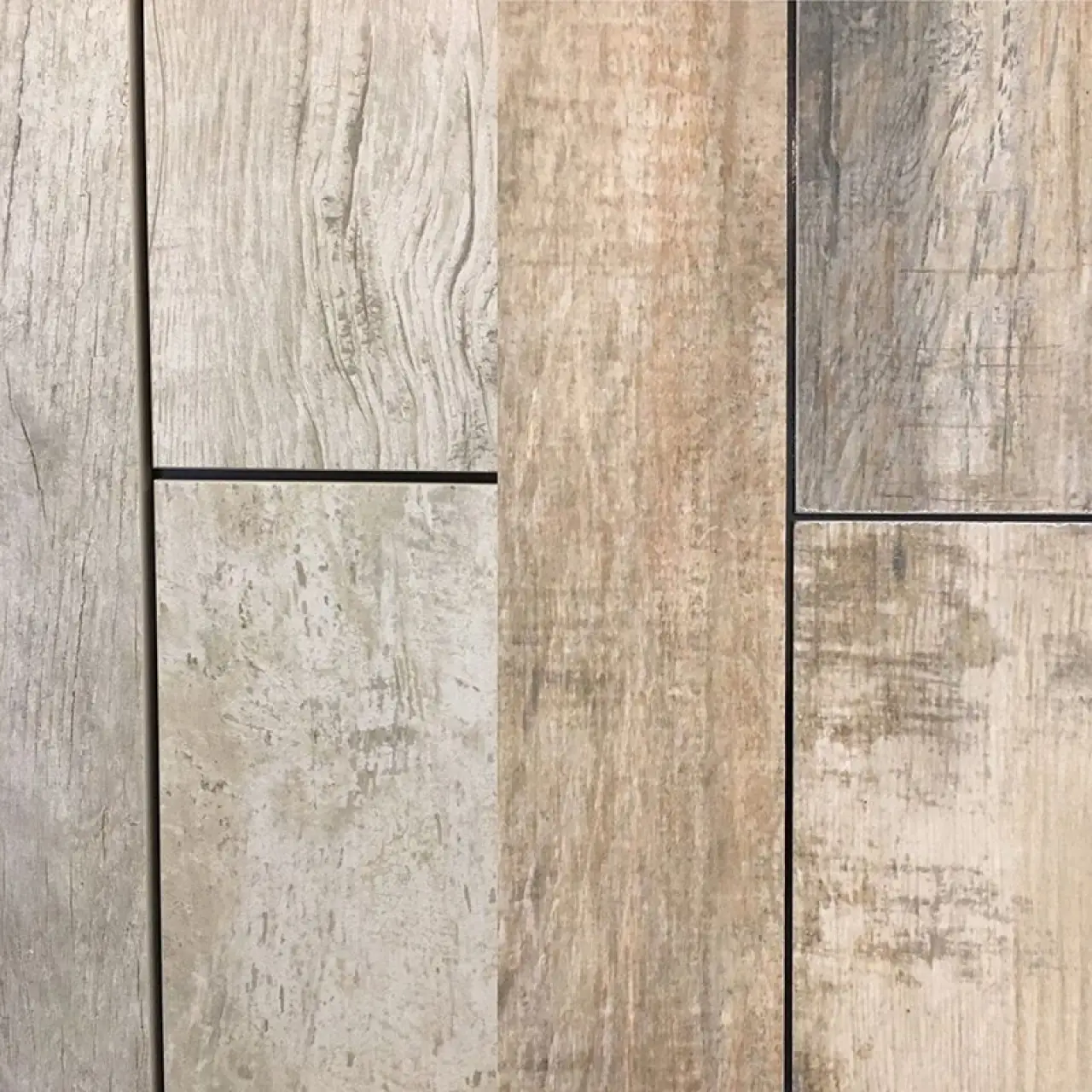 Gray and beige porcelain tile planks with varied wood-grain patterns.