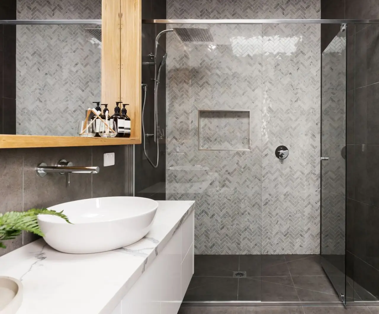 marble chevron shower tile wall with gray floor tiles