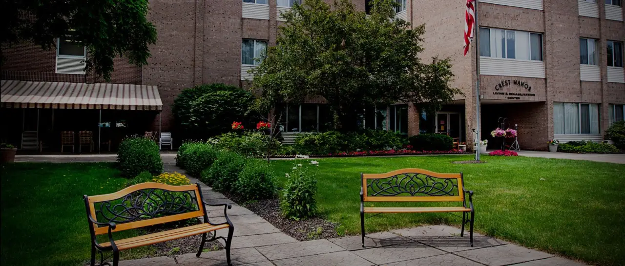 Benches and gardens outside Crest Manor Living and Rehabilitation Center