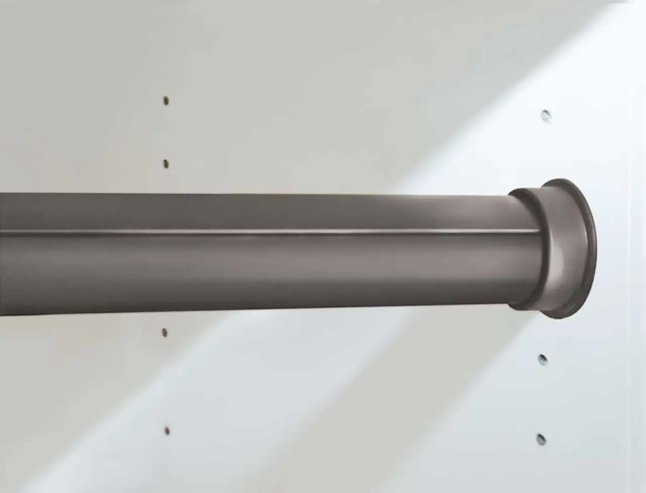 A close-up of a dark metal closet rod installed on a white wall with mounting brackets.