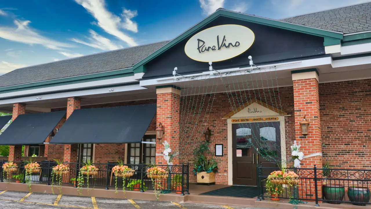 Pane Vino On the Avenue exterior in Pittsford with a flower-lined entrance.