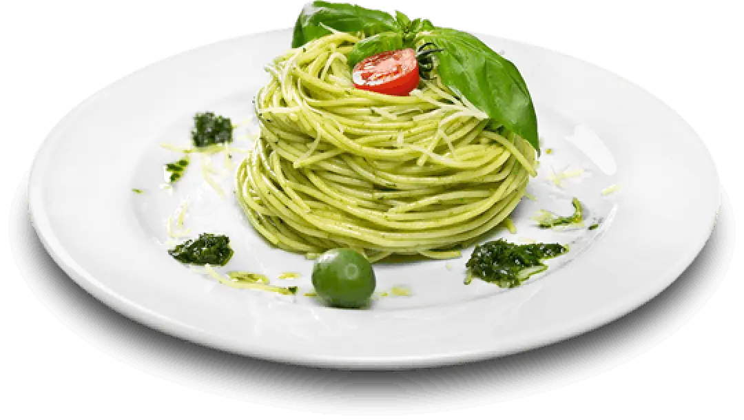 A plate of pesto spaghetti topped with basil and a cherry tomato.