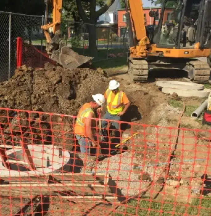two men working at a dig site