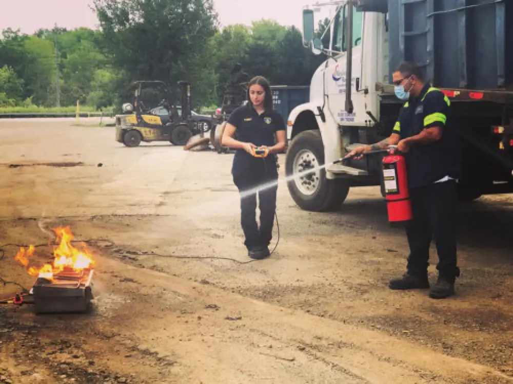 man putting out fire with fire extinguisher
