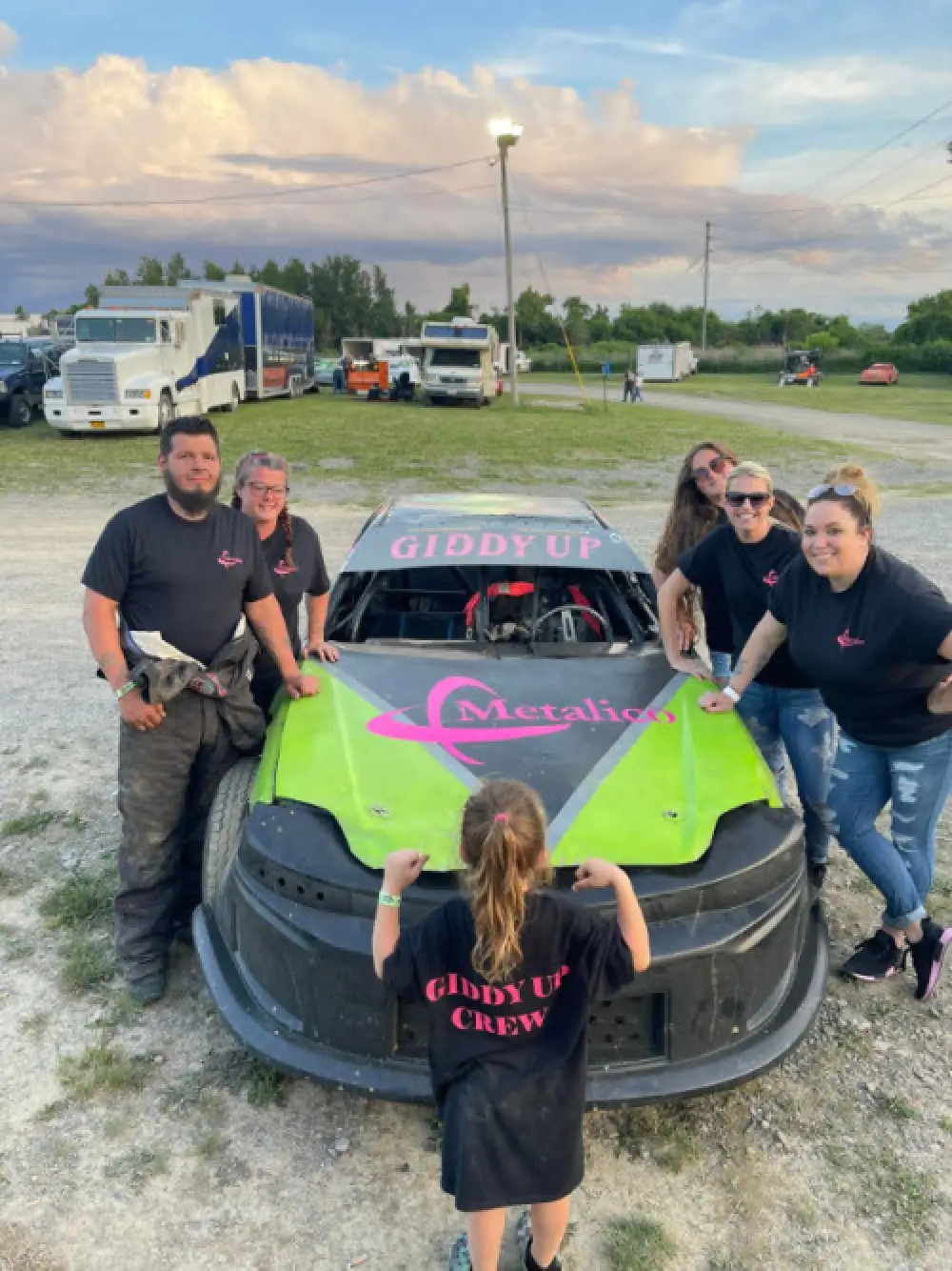 group of people with metalico car