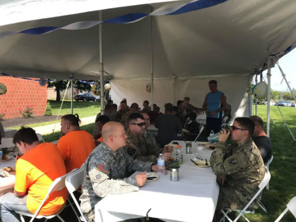 group of people sitting under a tent